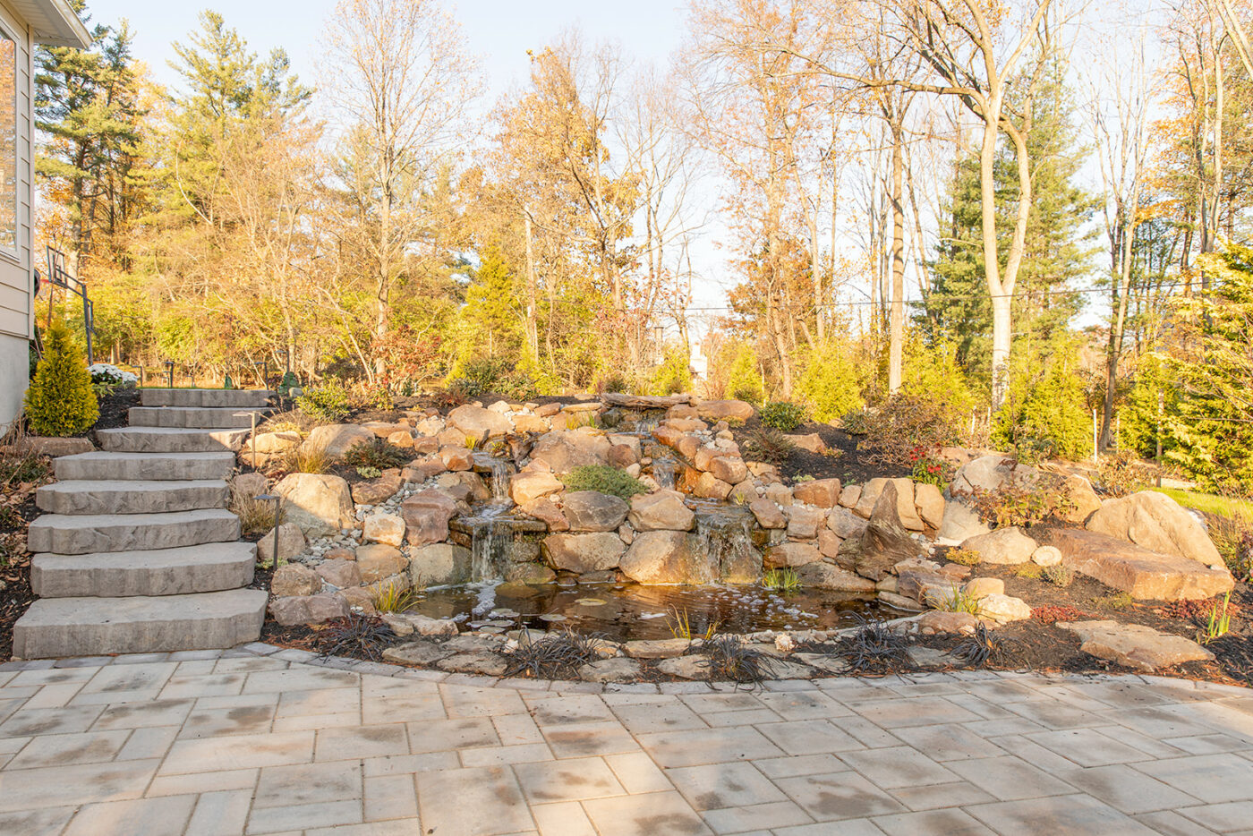 A backyard patio and rock garden hardscape installation in PA by Millstream Landscapes