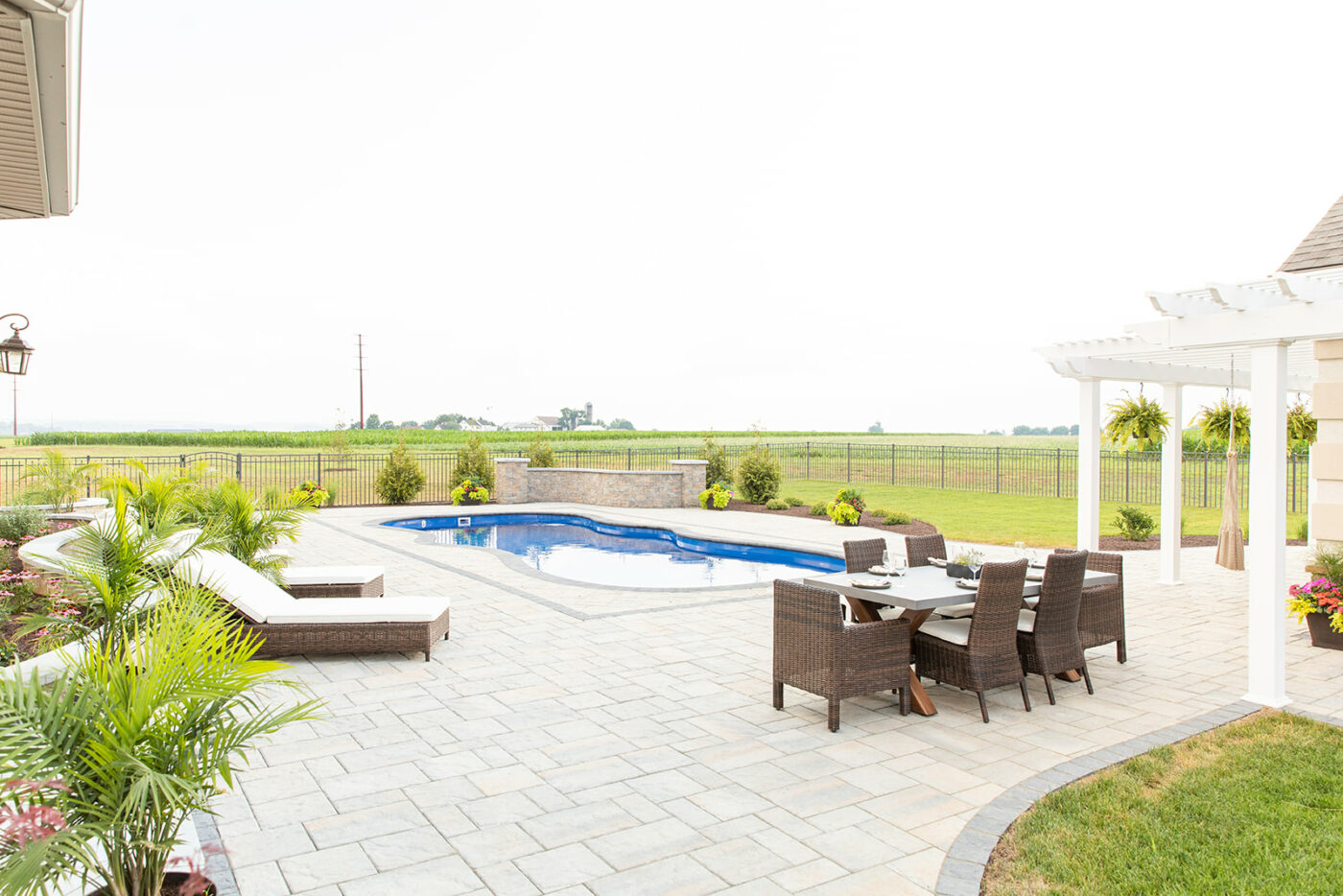 Swimming pool patio hardscape installation in PA by Millstream Landscape.