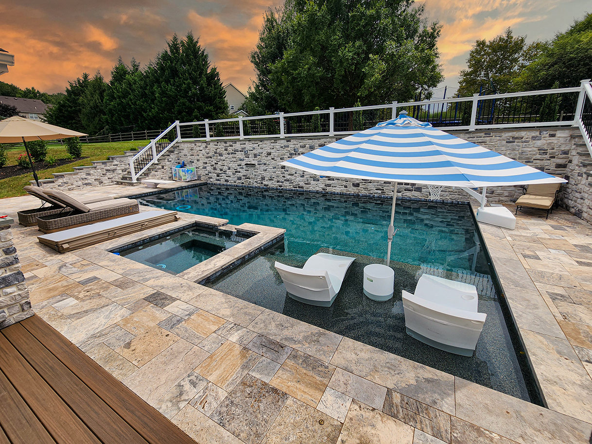 A Multilevel Swimming Pool Patio Oasis 14 Poolside Patio with water feature retaining wall