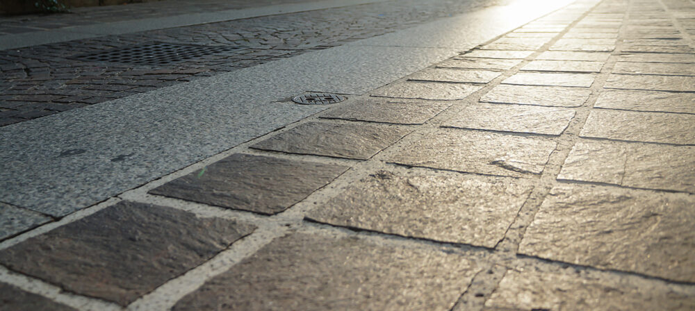 an,old,street,of,an,italian,city,with,stone,pavers