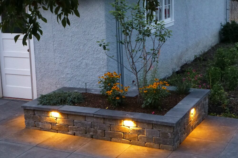 How To Install Low Voltage Landscape Lighting 5 low voltage lights in a wall around a garden bed