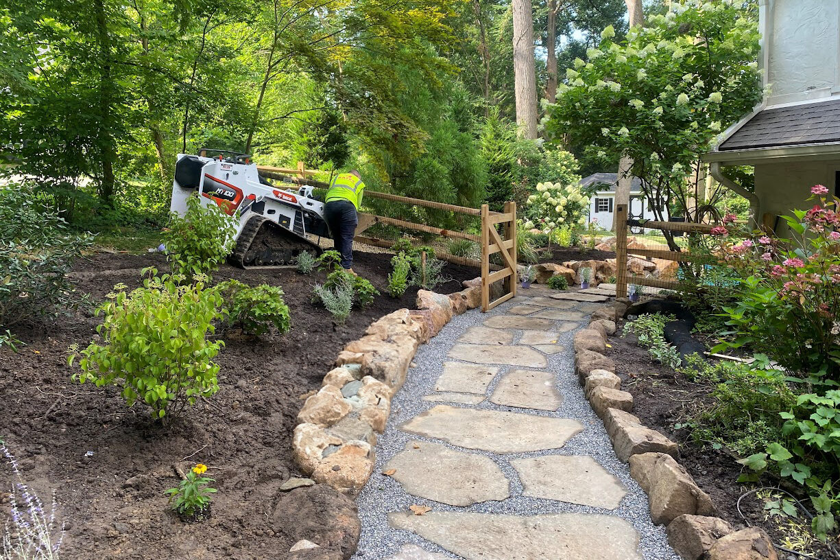 Stunning Outdoor Space Transformation with Boulder Retaining Walls and Flagstone Walkway 10 irregular flagstone and natural paver walkway framing garden with boulder retaining wall